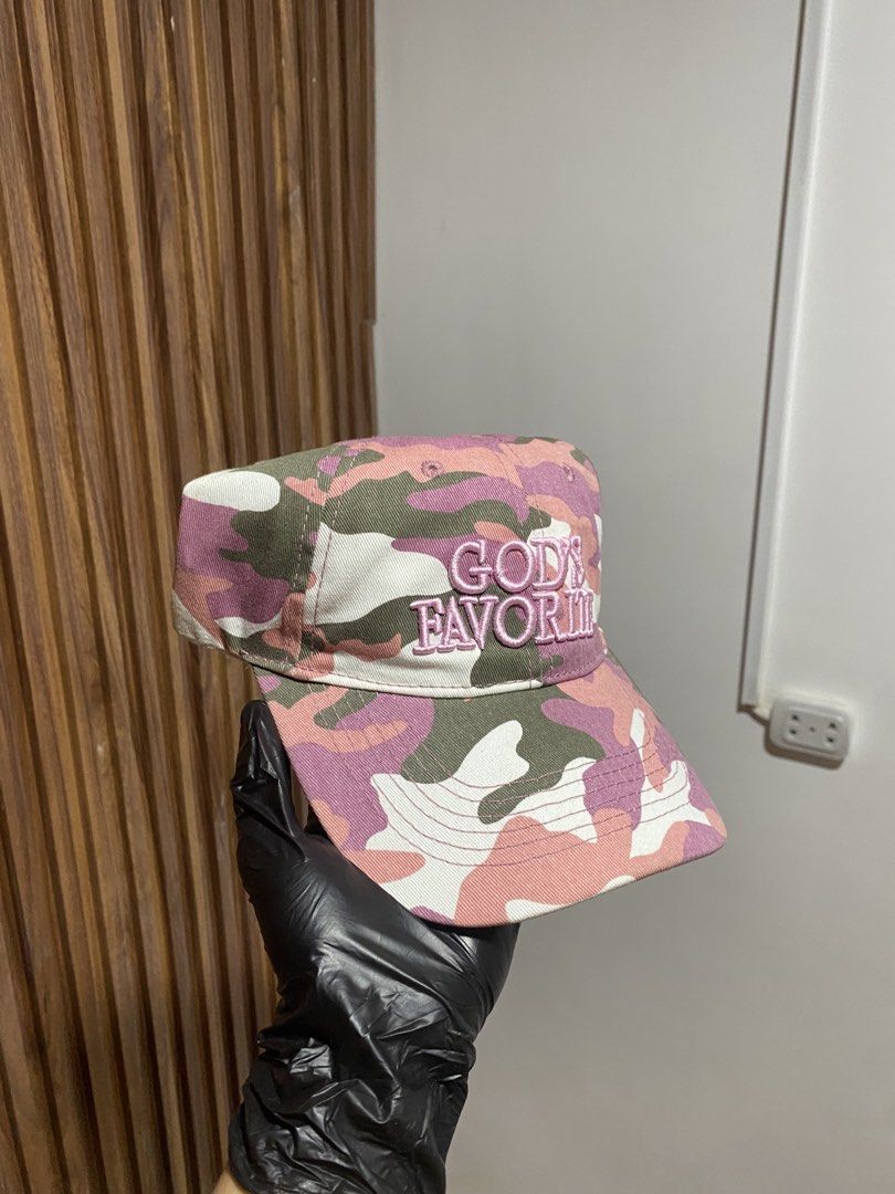 Pink Camo God's Favorite Baseball Cap (Category: Caps & Hats) located in Caloocan City. Submitted by heatedcaps4425 (Listing ID 1467802034, Image 2). Description: Pink camouflage baseball cap with embroidered lettering across the front reading God's Favorite. Adjustable strapback closure in the back. Interior shows 100 percent cotton tag and clean white sweatband lining. Unstructured low profile fit. Great streetwear accessory..