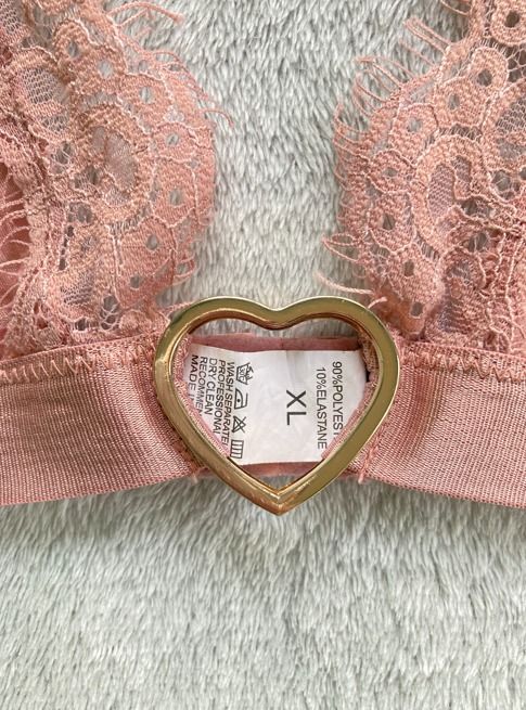 Pink Lace Bralette (Category: Undergarments & Loungewear) located in Rizal. Submitted by sheeraay (Listing ID 1467651272, Image 3). Description: - Style: Pink lace bralette with scalloped edges and a gold-tone heart-shaped ring at the center front - Size: XL.