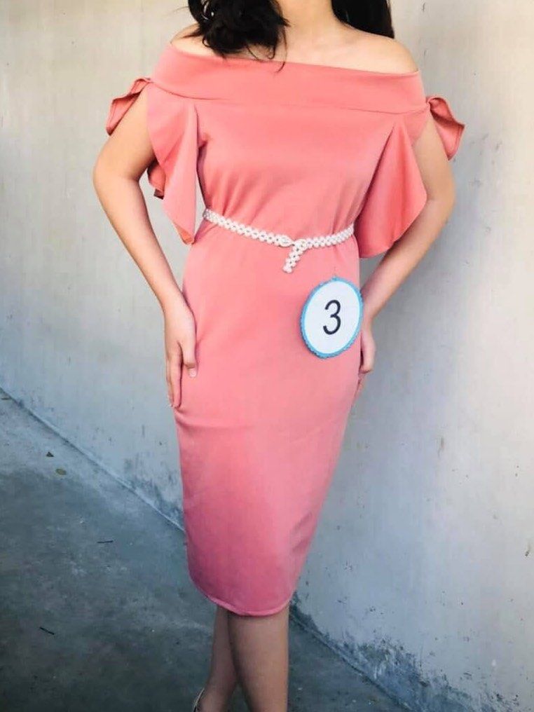Pink Off-Shoulder Midi Dress (Category: Dresses) located in Manila. Submitted by shecuratedit (Listing ID 1467666250, Image 1). Description: - Color & Style: Pink off-shoulder pencil midi dress with ruffled sleeves - Included: Thin white pearl bead belt - Length: Knee-length - Condition: Worn once for a pageant, contestant #3 tag still pinned; clean with no stains or damage - Environment: From a smoke-free home.