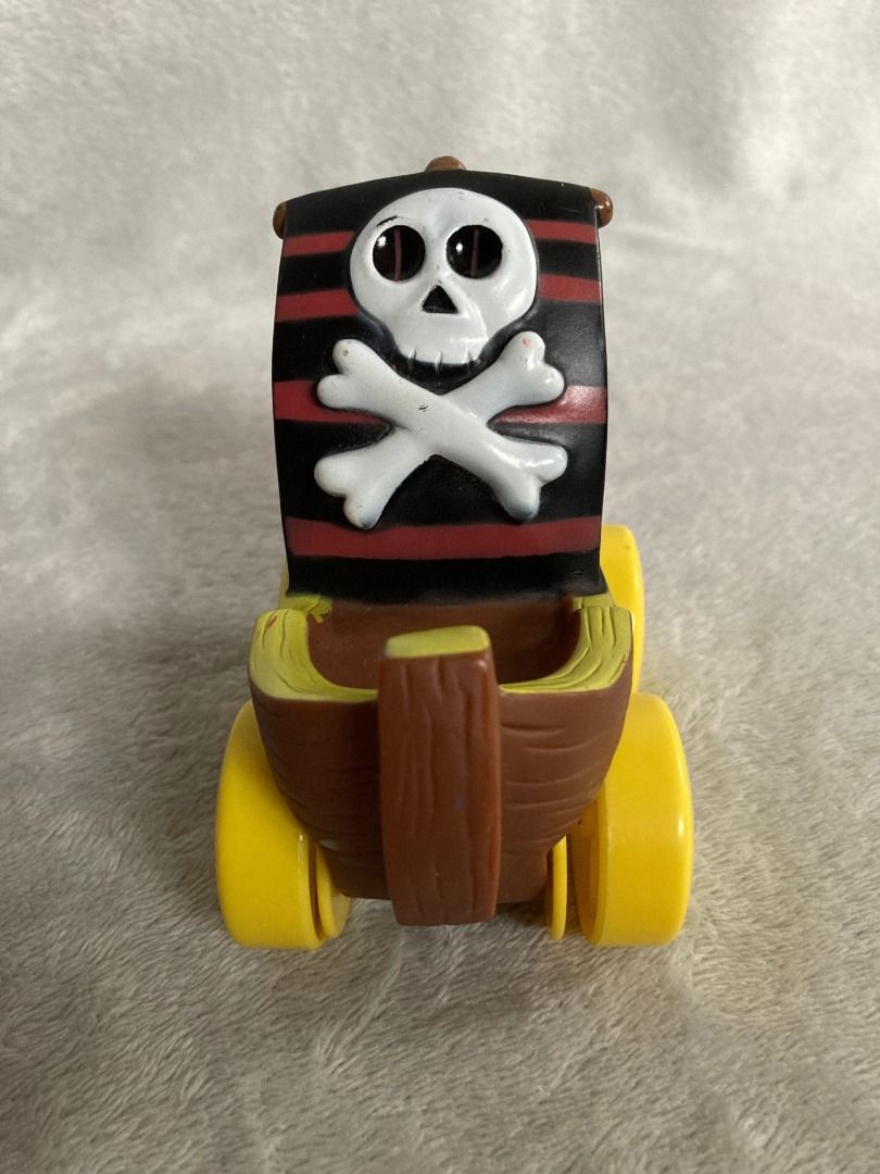Pirate Ship Toy Vehicle (Category: Kids Toys) located in Rizal. Submitted by sheeraay (Listing ID 1467703309, Image 3). Description: - Fun pirate-themed toy car with a realistic wood-plank molded brown body - Features eye-catching big yellow wheels and blue side window graphics - Equipped with a cool sail featuring a classic red, black, and white skull-and-crossbones design - Rolls smoothly on hard surfaces for endless playtime adventures - Perfe