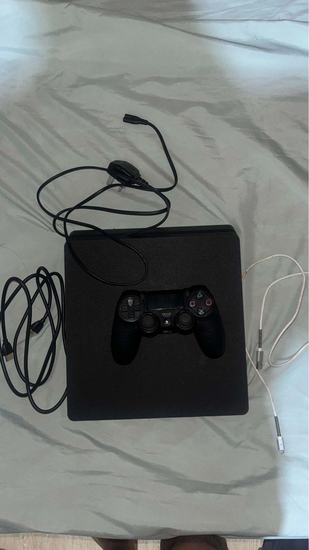 PlayStation 4 Slim Console with Controller and Cables (Category: PlayStation) located in Makati City. Submitted by itsgongju (Listing ID 1467651779, Image 1). Description: - Black PlayStation 4 console in great working condition - 1x Wireless controller with protective black silicone grip cover - Complete with power cable and 2x USB charging cables - Plug-and-play ready - Meetup or shipping options available (PM for details).