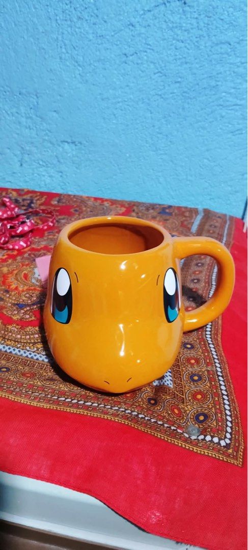 Pokémon Charmander Shaped Ceramic Mug 20 oz (Category: Coffee & Tea Tableware) located in Santa Rosa. Submitted by alexandraa_togepi (Listing ID 1467617552, Image 1). Description: - Official 2023 Silver Buffalo Pokémon release - Adorable Charmander shaped ceramic mug in vibrant orange - Generous 20-ounce capacity for your favorite hot drinks - Hand wash only (not microwave or dishwasher safe) - Perfect addition to any Pokémon collection.