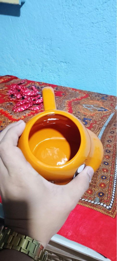 Pokémon Charmander Shaped Ceramic Mug 20 oz (Category: Coffee & Tea Tableware) located in Santa Rosa. Submitted by alexandraa_togepi (Listing ID 1467617552, Image 3). Description: - Official 2023 Silver Buffalo Pokémon release - Adorable Charmander shaped ceramic mug in vibrant orange - Generous 20-ounce capacity for your favorite hot drinks - Hand wash only (not microwave or dishwasher safe) - Perfect addition to any Pokémon collection.