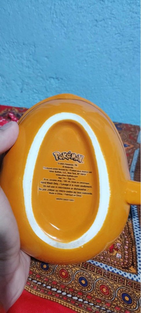 Pokémon Charmander Shaped Ceramic Mug 20 oz (Category: Coffee & Tea Tableware) located in Santa Rosa. Submitted by alexandraa_togepi (Listing ID 1467617552, Image 2). Description: - Official 2023 Silver Buffalo Pokémon release - Adorable Charmander shaped ceramic mug in vibrant orange - Generous 20-ounce capacity for your favorite hot drinks - Hand wash only (not microwave or dishwasher safe) - Perfect addition to any Pokémon collection.
