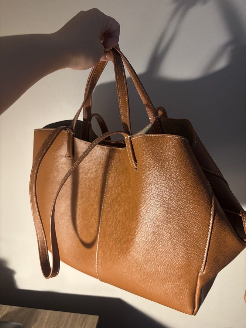 Polène Tan Leather Tote Bag (Category: Luxury Bags & Wallets) located in Dumaguete. Submitted by randompullouts (Listing ID 1467741388, Image 3). Description: Gold-foil embossed logo on the front lower corner. Open top interior with a matching removable base insert. Clean interior lining with generous space for daily essentials..