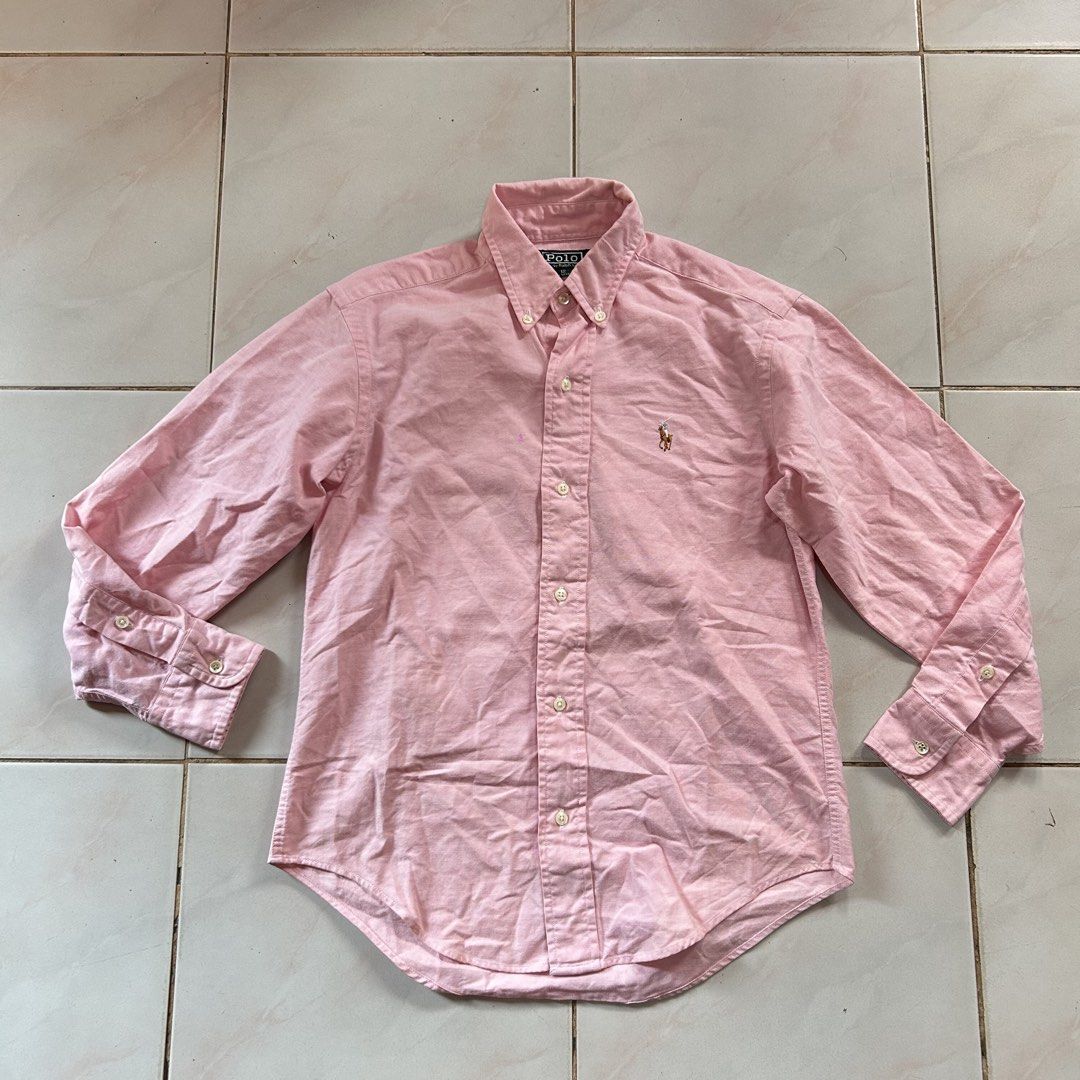 Polo by Ralph Lauren Pink Oxford 🥵 (Category: Babies & Kids Fashion) located in Jinoba-an. Submitted by eegiboy (Listing ID 1467649607, Image 1). Description: - Brand: Polo by Ralph Lauren - Style: Classic pink Oxford button-down shirt - Material: 100% breathable cotton - Fit & Size: Classic fit, tagged size 12 - Details: Signature embroidered pony logo, long sleeves with adjustable cuffs - Condition: Great pre-owned condition - Origin: Made in 