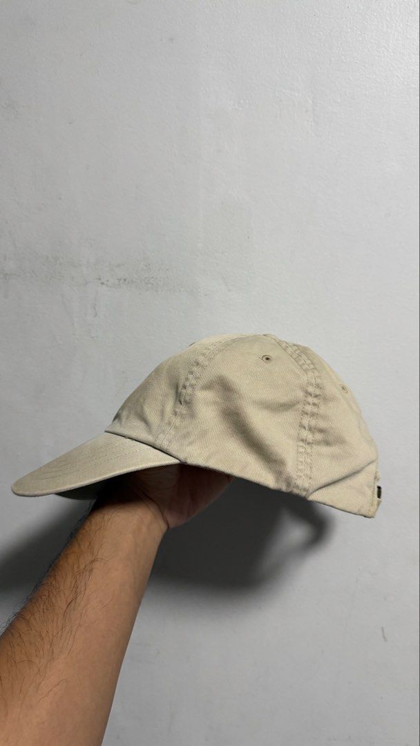 Polo Ralph Lauren Beige Baseball Cap (Category: Caps & Hats) located in Quezon City. Submitted by kobeeeee_12 (Listing ID 1467738505, Image 2). Description: - Brand: Polo Ralph Lauren - Color: Classic beige with dark navy blue embroidered pony logo and 'POLO' lettering on the back - Material: 100% cotton twill (Made in Bangladesh) - Fit: Adjustable strap with brass buckle slider.
