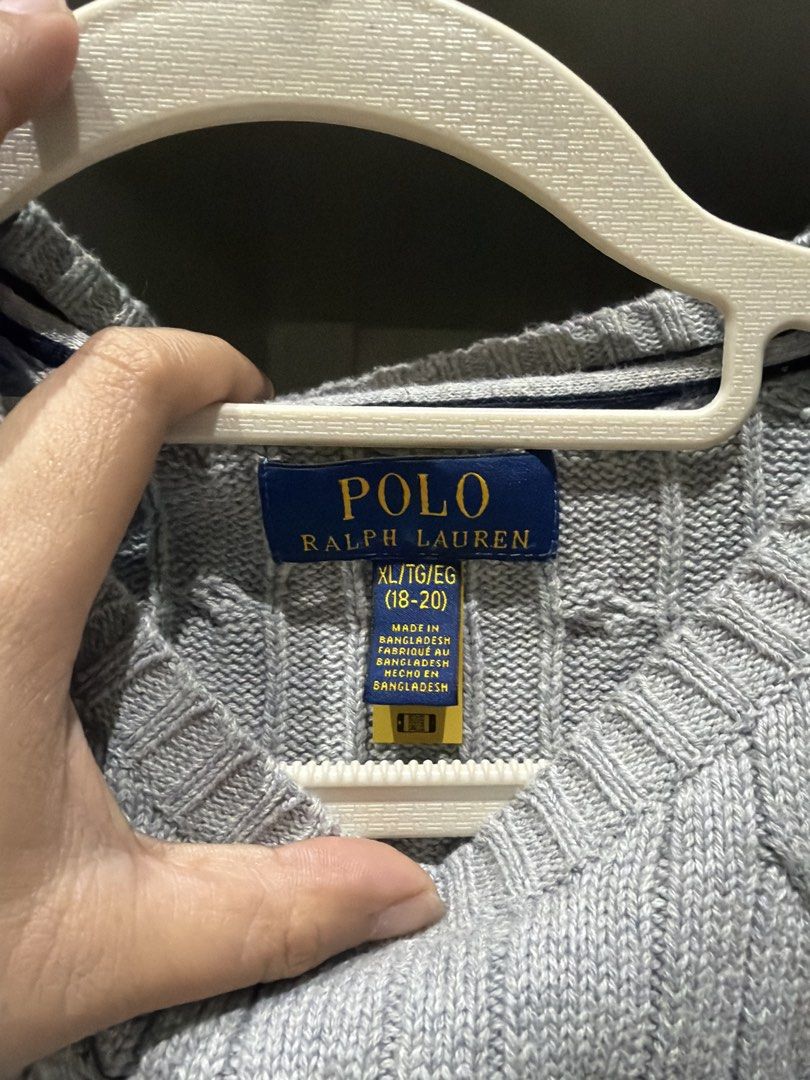 Polo Ralph Lauren Cable Knit Grey Sweater (Category: Longsleeves) located in Batangas. Submitted by luxuryinmyclowset (Listing ID 1467732090, Image 2). Description: - Brand: Polo Ralph Lauren - Color: Grey with navy pony logo - Style: Cable knit crewneck sweater - Size: XL (fits ages 18-20) - Condition: Clean collar tags, soft textured knit - Features: Long sleeves, ribbed cuffs, great for layering.