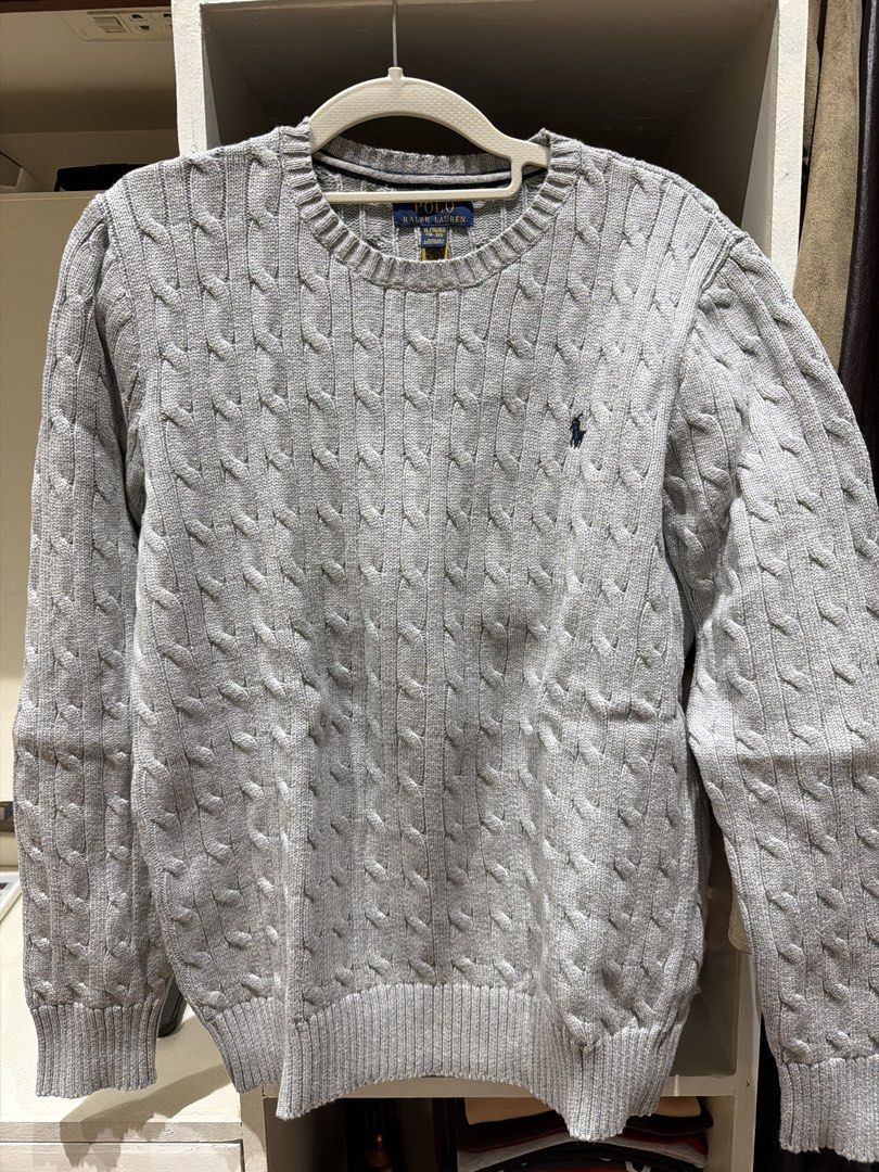 Polo Ralph Lauren Cable Knit Grey Sweater (Category: Longsleeves) located in Batangas. Submitted by luxuryinmyclowset (Listing ID 1467732090, Image 1). Description: - Brand: Polo Ralph Lauren - Color: Grey with navy pony logo - Style: Cable knit crewneck sweater - Size: XL (fits ages 18-20) - Condition: Clean collar tags, soft textured knit - Features: Long sleeves, ribbed cuffs, great for layering.