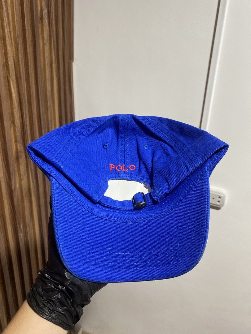 Polo Ralph Lauren Royal Blue Cap (Category: Caps & Hats) located in Caloocan City. Submitted by heatedcaps4425 (Listing ID 1467804346, Image 3). Description: - Brand: Polo Ralph Lauren - Color: Royal blue with bright red accents - Details: Embroidered red pony logo on front, red POLO lettering above back strap - Fit: Adjustable metal buckle closure - Condition: Brand new with tags attached.