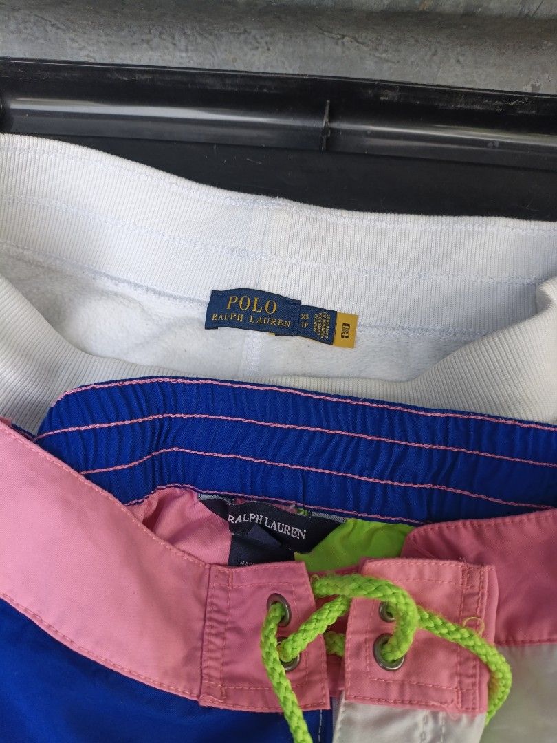 Polo Ralph Lauren Shorts Bundle Size XS (Category: Shorts) located in Maasim. Submitted by ukayganda25 (Listing ID 1467664879, Image 2). Description: - Brand: Polo Ralph Lauren - Size: Extra Small (XS) - Condition: 100% Authentic with inner tags and QR authenticity labels attached - Item 1: White fleece shorts with raw hems and an adjustable drawstring waist - Item 2: Vibrant color-block shorts featuring pink, blue, white, and green panels with a