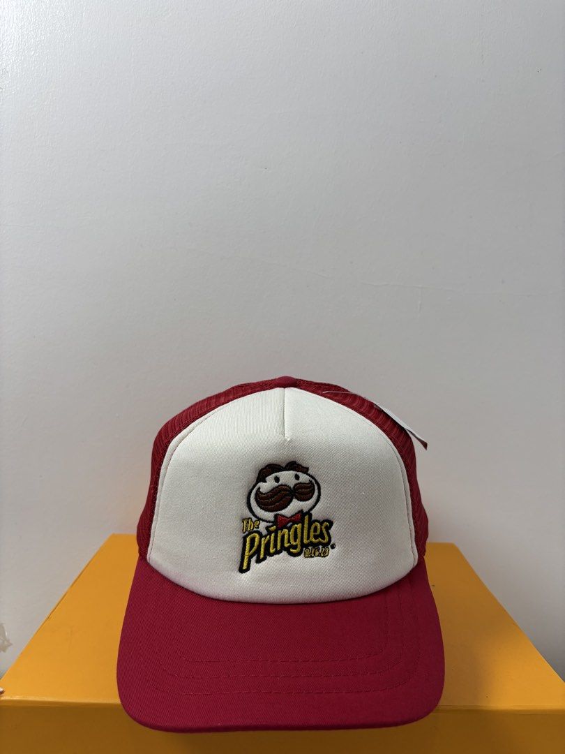Port Authority Pringles Trucker Hat Red White (Category: Caps & Hats) located in Marikina City. Submitted by zaxcheus_castillo1708 (Listing ID 1467654756, Image 1). Description: - Brand: Port Authority x Pringles - Design: Classic embroidered Pringles logo on white front panels - Colors: Red mesh back, red brim, and white front - Fit: Adjustable snapback closure for a custom fit - Condition: Brand new with original brand tags attached and clean i