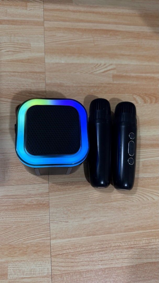 Portable Karaoke Bluetooth Speaker with Two Wireless Microphones (Category: Soundbars, Speakers & Amplifiers) located in Manila. Submitted by queenofthesea0202 (Listing ID 1467644753, Image 1). Description: - Complete set: Portable karaoke speaker and 2 wireless black microphones - Vibrant RGB lighting and stylish leather carrying strap - Wireless connectivity for phones and tablets - Compact and lightweight for parties, gatherings, and home use 