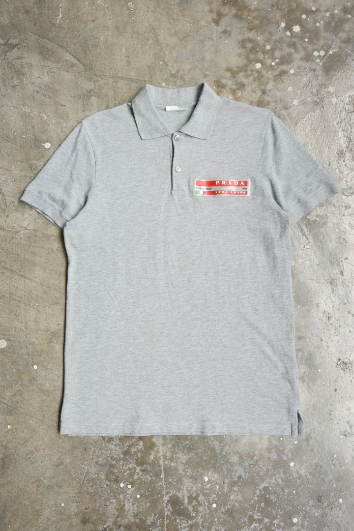 Prada - 2003 Luna Rossa Challenge Polo (Category: Tshirts & Polo Shirts ) located in Manila. Submitted by graymatter_ (Listing ID 1467644625, Image 1). Description: Prada - 2003 Luna Rossa Challenge Polo *Team Member Exclusive Tagged Size: (fits L) Flaws: Cut Size Tag Condition: 100% Cotton Made in: China Dimensions Length: 28.5 Width: 21 Shoulder: 17 Sleeve: 9.