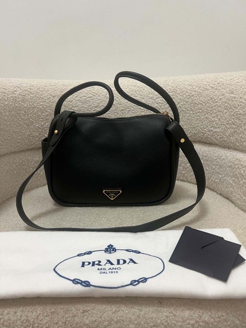 Prada Darling Two Way Bag (Category: Shoulder Bags) located in Paoay. Submitted by rvf1230 (Listing ID 1467659053, Image 3). Description: - Brand: Prada - Color: Classic Black - Material: Smooth, high-quality leather - Hardware: Gold-tone with iconic triangle logo - Features: Double top handles, adjustable strap, and secure zip-top closure - Condition: Excellent, clean structure with minimal wear - Inclusions: Original black presentation box, dus