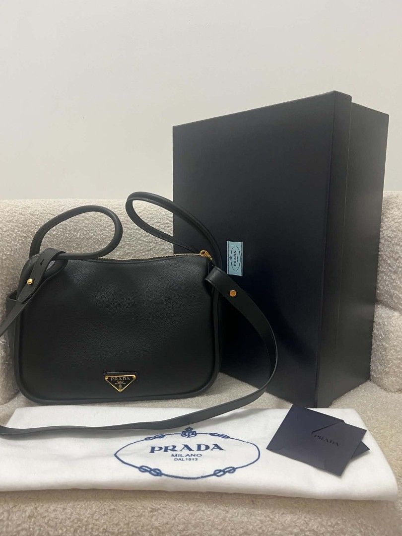 Prada Darling Two Way Bag (Category: Shoulder Bags) located in Paoay. Submitted by rvf1230 (Listing ID 1467659053, Image 2). Description: - Brand: Prada - Color: Classic Black - Material: Smooth, high-quality leather - Hardware: Gold-tone with iconic triangle logo - Features: Double top handles, adjustable strap, and secure zip-top closure - Condition: Excellent, clean structure with minimal wear - Inclusions: Original black presentation box, dus