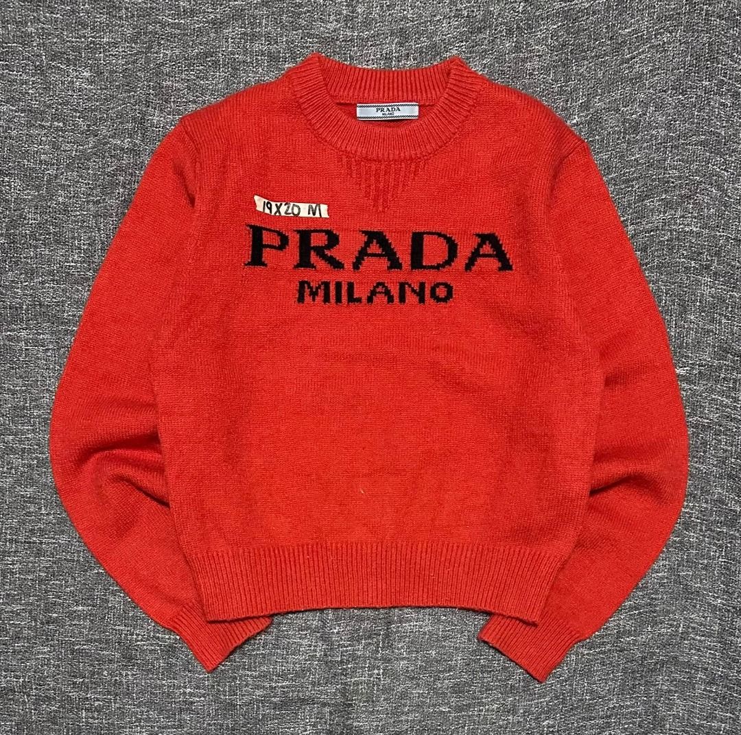 PRADA MILANO red crew-neck sweater (Category: Coats, Jackets and Outerwear) located in Manila. Submitted by thriftedbykab (Listing ID 1467709426, Image 1). Description: -Brand: PRADA MILANO -NO WASH TAG -Size: (M) -Width: 19| Length: 27 -Condition: As new -Color Rate: 9.8/10 -Issue: NEED WASH.