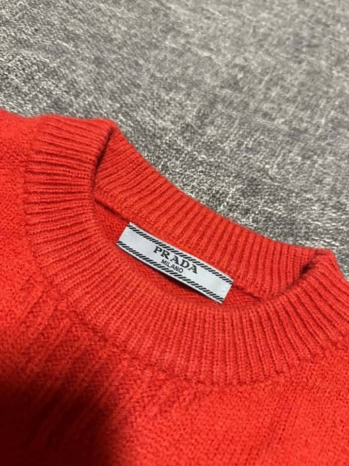 PRADA MILANO red crew-neck sweater (Category: Coats, Jackets and Outerwear) located in Manila. Submitted by thriftedbykab (Listing ID 1467709426, Image 2). Description: -Brand: PRADA MILANO -NO WASH TAG -Size: (M) -Width: 19| Length: 27 -Condition: As new -Color Rate: 9.8/10 -Issue: NEED WASH.