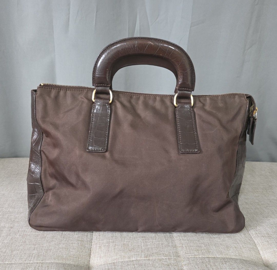 Prada Nylon and Crocodile Embossed Leather Trim Satchel (Category: Luxury Bags & Wallets) located in Binan City. Submitted by karosellescloset (Listing ID 1467660490, Image 1). Description: Croc-Embossed or Genuine Exotic Trim) Top Handle Satchel / Tote. - ​Featuring a structured nylon body paired with exotic leather handles and gussets/trim - chocolate brown in color - hand bag with leather trims on the side.