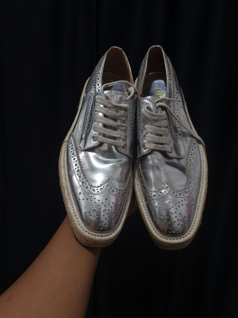Prada Silver Metallic Brogue Platform Shoes Size 37 (Category: Loafers) located in Baguio. Submitted by solo_ukay (Listing ID 1467788728, Image 2). Description: - Brand: Prada - Style: Silver metallic leather brogues with wingtip perforations - Size: 37 (stamped inside) - Sole: Chunky platform with a stylish green stripe and woven jute detail - Branding: Gold Prada logo on insoles and debossed on rubber outsoles - Condition: Good pre-loved condit