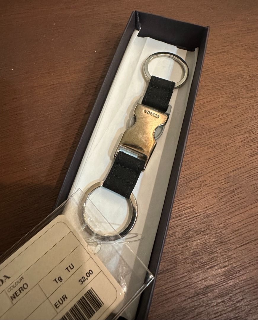 Prada Sport Keyring Black 4AP050 (Category: Luxury Accessories) located in San Juan City. Submitted by looneyc (Listing ID 1467628442, Image 3). Description: - Authentic Prada Sport keyring in black (Model 4AP050) - Features metal buckle hardware with engraved Prada branding - Equipped with double split rings for convenience - Brand new, never used, and properly stored - Complete with original box and store tag Never used. Just kept in storage. W