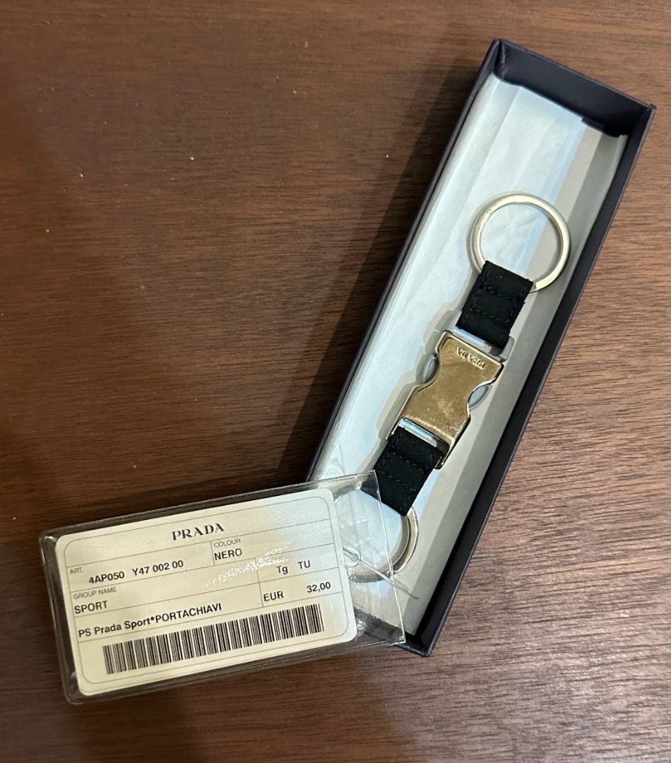 Prada Sport Keyring Black 4AP050 (Category: Luxury Accessories) located in San Juan City. Submitted by looneyc (Listing ID 1467628442, Image 1). Description: - Authentic Prada Sport keyring in black (Model 4AP050) - Features metal buckle hardware with engraved Prada branding - Equipped with double split rings for convenience - Brand new, never used, and properly stored - Complete with original box and store tag Never used. Just kept in storage. W