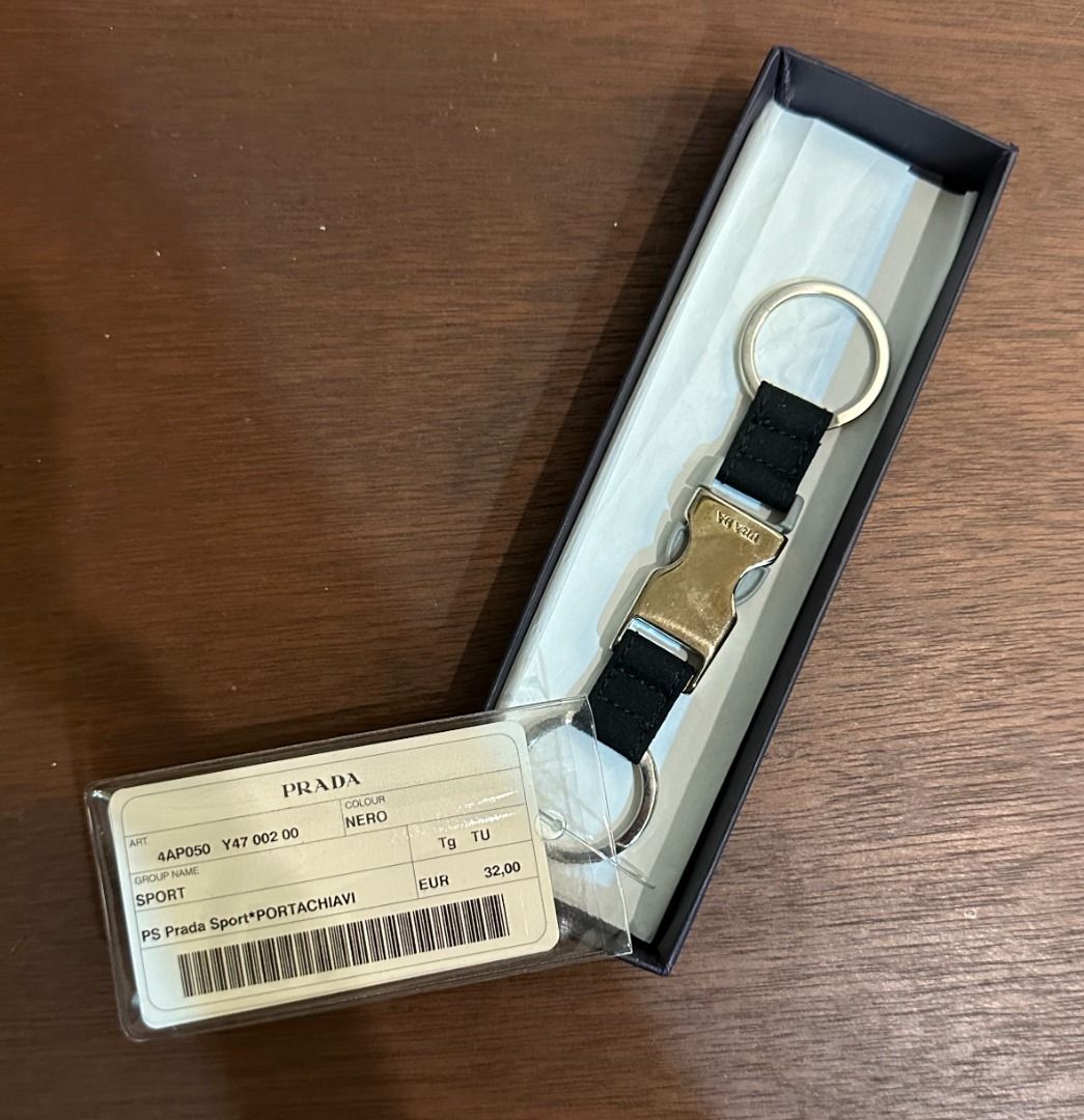 Prada Sport Keyring Black 4AP050 (Category: Luxury Accessories) located in San Juan City. Submitted by looneyc (Listing ID 1467628442, Image 2). Description: - Authentic Prada Sport keyring in black (Model 4AP050) - Features metal buckle hardware with engraved Prada branding - Equipped with double split rings for convenience - Brand new, never used, and properly stored - Complete with original box and store tag Never used. Just kept in storage. W
