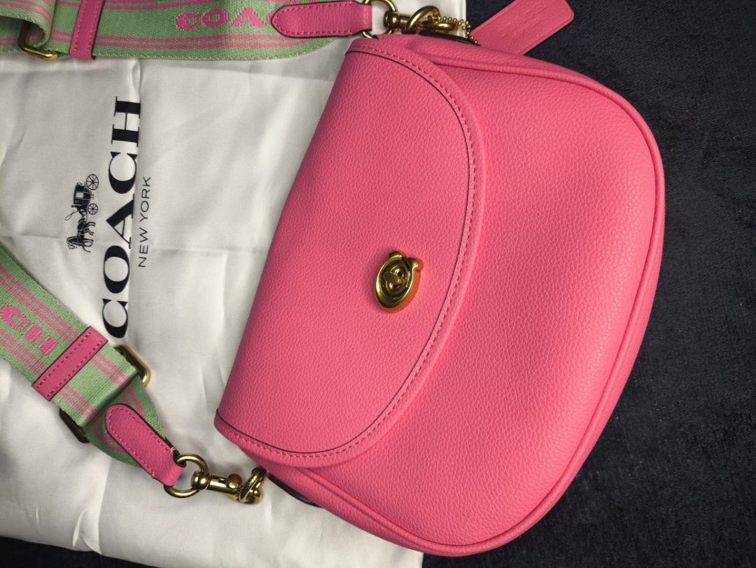 preloved 🩷 Coach Willow Saddle Bag (Category: Shoulder Bags) located in Las Pinas. Submitted by rose.luab (Listing ID 1467791660, Image 2). Description: preloved Coach Willow Saddle Bag in a hot pink / petunia colorway. • Material: Polished pebbled leather with a signature turn lock closure • Design Features: Equestrian-inspired saddle silhouette with interchangeable straps (including a wide webbed logo strap and a matching leather strap) • Dime
