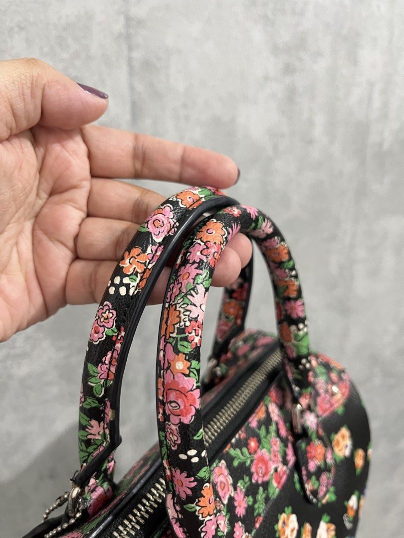 Preloved Auth 💯Coach Floral Print Bennett Black (Category: Luxury Bags & Wallets) located in Calamba. Submitted by thedreambags.ph (Listing ID 1467612420, Image 2). Description: - Brand: Coach - Design: Vibrant colorful floral print on black base with striking blue rose side panels - Hardware & Details: Black leather hangtag included - Features: Dual rolled carrying handles, secure top zip closure, and structured flat bottom for stability - Cond