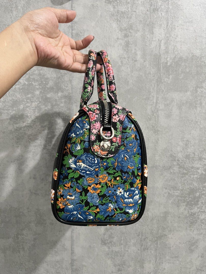 Preloved Auth 💯Coach Floral Print Bennett Black (Category: Luxury Bags & Wallets) located in Calamba. Submitted by thedreambags.ph (Listing ID 1467612420, Image 3). Description: - Brand: Coach - Design: Vibrant colorful floral print on black base with striking blue rose side panels - Hardware & Details: Black leather hangtag included - Features: Dual rolled carrying handles, secure top zip closure, and structured flat bottom for stability - Cond