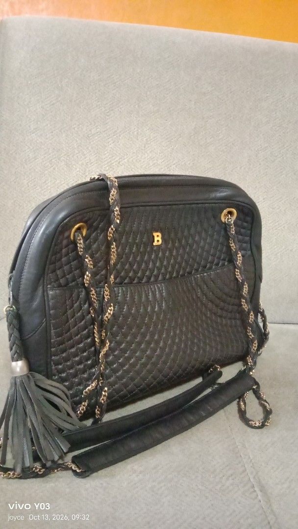 Preloved Bally Quilted Leather Shoulder Bag with Chain Strap (Category: Luxury Bags & Wallets) located in Cabuyao City. Submitted by selections888 (Listing ID 1467612670, Image 1). Description: - Authentic black quilted leather Bally handbag - Elegant gold-tone hardware and chain shoulder straps - Chic leather tassel accent on the zipper - Convenient exterior slip pocket for quick access - Secure top zip closure with smooth leather gussets - Clea