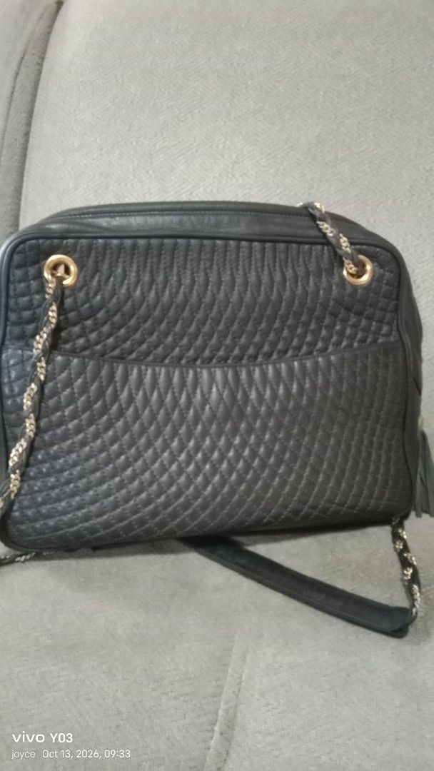Preloved Bally Quilted Leather Shoulder Bag with Chain Strap (Category: Luxury Bags & Wallets) located in Cabuyao City. Submitted by selections888 (Listing ID 1467612670, Image 3). Description: - Authentic black quilted leather Bally handbag - Elegant gold-tone hardware and chain shoulder straps - Chic leather tassel accent on the zipper - Convenient exterior slip pocket for quick access - Secure top zip closure with smooth leather gussets - Clea