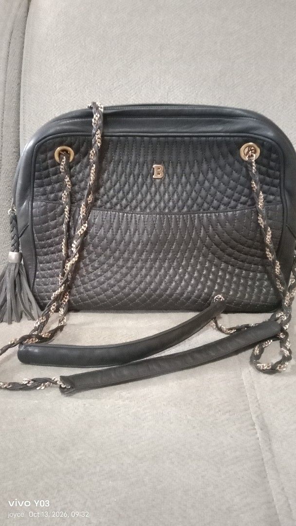 Preloved Bally Quilted Leather Shoulder Bag with Chain Strap (Category: Luxury Bags & Wallets) located in Cabuyao City. Submitted by selections888 (Listing ID 1467612670, Image 2). Description: - Authentic black quilted leather Bally handbag - Elegant gold-tone hardware and chain shoulder straps - Chic leather tassel accent on the zipper - Convenient exterior slip pocket for quick access - Secure top zip closure with smooth leather gussets - Clea