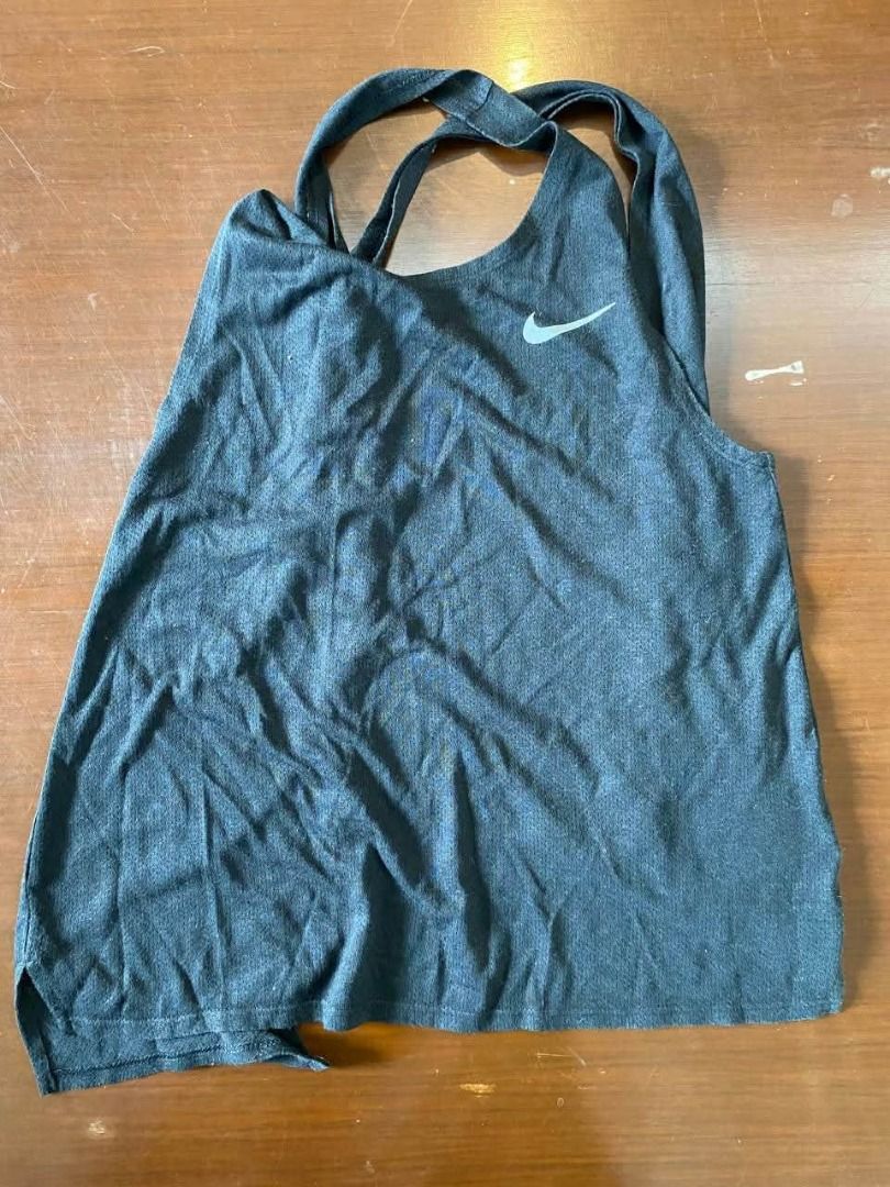 Preloved Nike Tank Top Black S (Category: Activewear) located in Muntinlupa City. Submitted by irene.aragon.navarro (Listing ID 1467673522, Image 1). Description: - Brand: Nike - Item: Women's Activewear Tank Top - Color: Dark Grey with small white Swoosh logo - Design: Sleeveless, racerback with trendy crossed back straps - Fit: Standard fit - Material: Soft, breathable athletic fabric - Condition: Excellent - Perfect for: Workouts, gym sessions