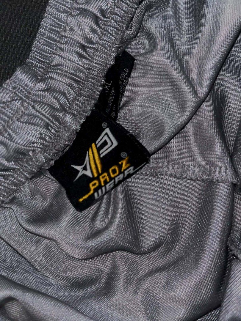 Proz Wear Silver (Category: Shorts) located in Manila. Submitted by xlyssaa_20 (Listing ID 1467795735, Image 2). Description: - Brand: Proz Wear - Size: XL - Color: Silver - Material: Lightweight, shiny polyester - Features: Adjustable drawstring waistband and embroidered logo on the left leg hem.
