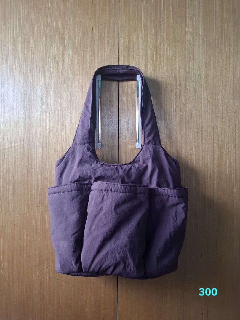 Puffy shoulder bag in dusty purple (Category: Shoulder Bags) located in Pasay City. Submitted by emilia1102 (Listing ID 1467789170, Image 1). Description: - Color & Material: Dusty purple soft nylon with a chic quilted texture - Storage: Roomy main compartment for daily essentials plus 3 large front pockets - Comfort: Wide straps designed for comfortable shoulder wear - Style: Lightweight and casual, perfect for everyday use.