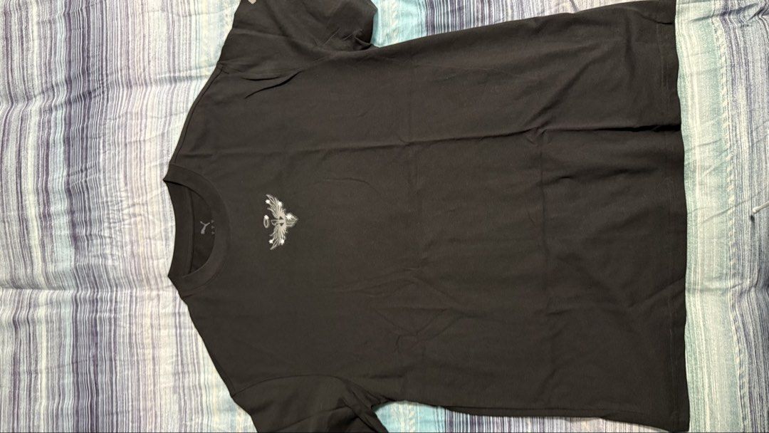 Puma Black Graphic T-Shirt Size S (Category: Shirts) located in Quezon City. Submitted by kobeeeee_12 (Listing ID 1467642912, Image 1). Description: - Brand: Puma - Color: Black with silver angel wing graphic on chest - Size: S (Relaxed fit) - Measurements: Pit-to-pit approx. 21 inches, Length approx. 28 inches - Details: Crew neck, short sleeves, clean fabric with tag intact - Condition: Excellent, comfortable for everyday wear.