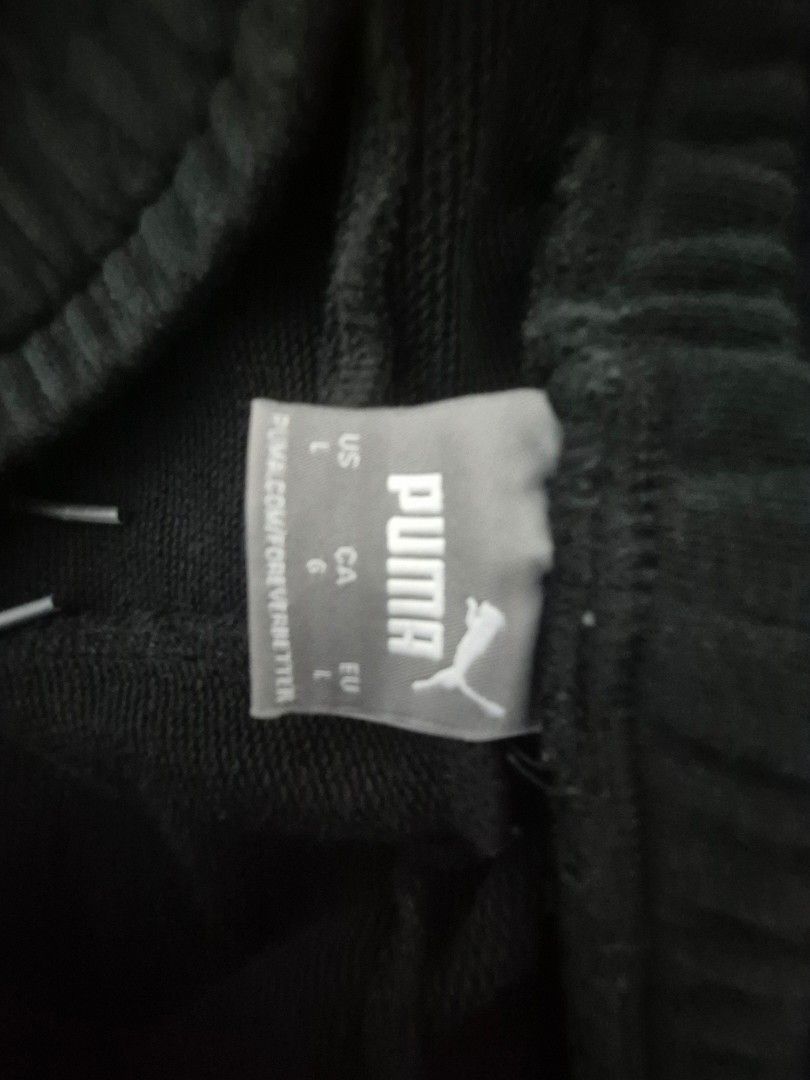 Puma Black Sweatpants Size L (Category: Joggers) located in Marikina City. Submitted by raesales (Listing ID 1467711997, Image 2). Description: - Brand: Puma - Color: Black - Size: Large (L) - Style: Classic athletic joggers with elastic waistband and ribbed cuffs - Detail: White Puma logo printed on the left thigh - Material: 100% cotton - Style Number: 586718-01 (verified on inner label) - Origin: Made in Cambodia.