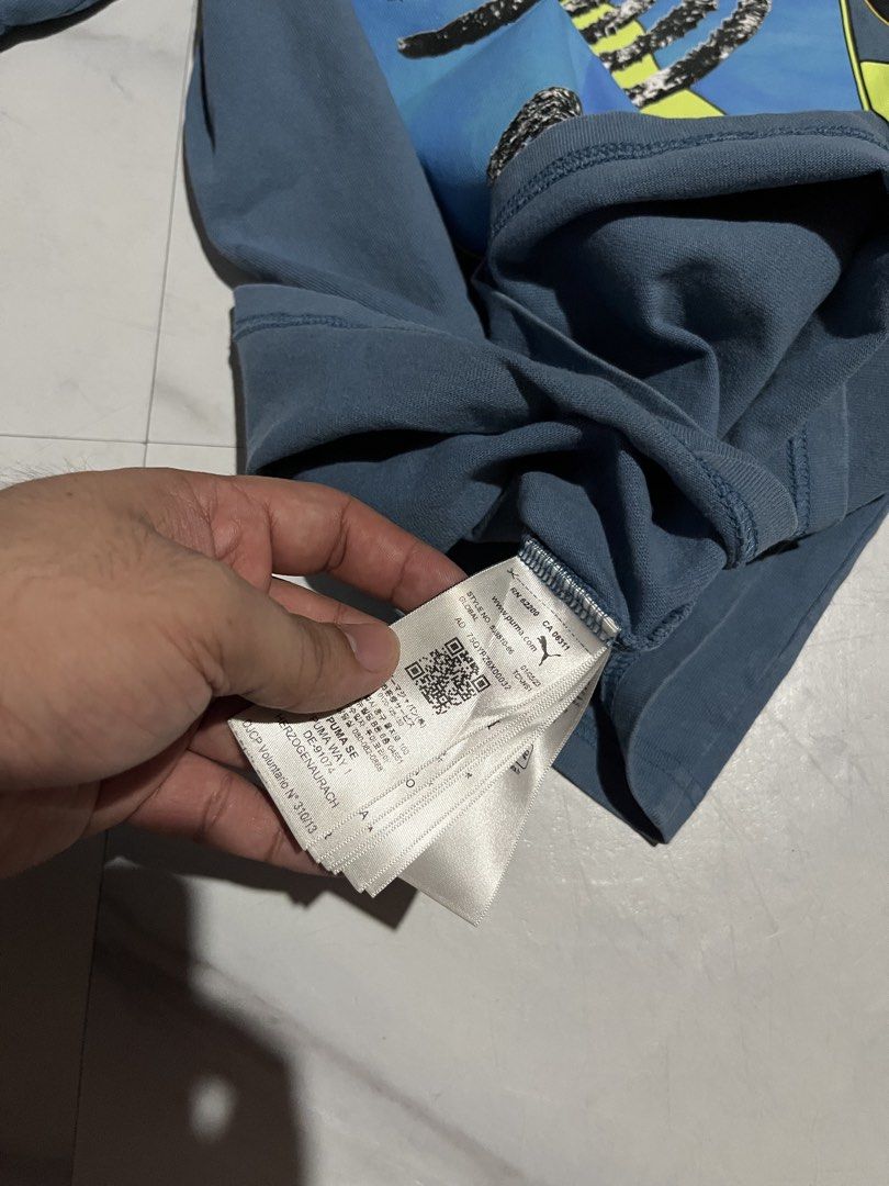 Puma x PAM Perks and Mini Graphic Tee (Category: Shirts) located in Cavite. Submitted by christianzuuu (Listing ID 1467662598, Image 3). Description: - Brand: Puma x P.A.M. (Perks and Mini) Collaboration - Color: Blue - Material: Soft, comfortable cotton - Design: Large spiral graphic print on front and back, with official collaboration patch on the sleeve - Size/Measurements: Chest width 21 inches, Length 28.5 inches - Mode of Payment: GCash, BP
