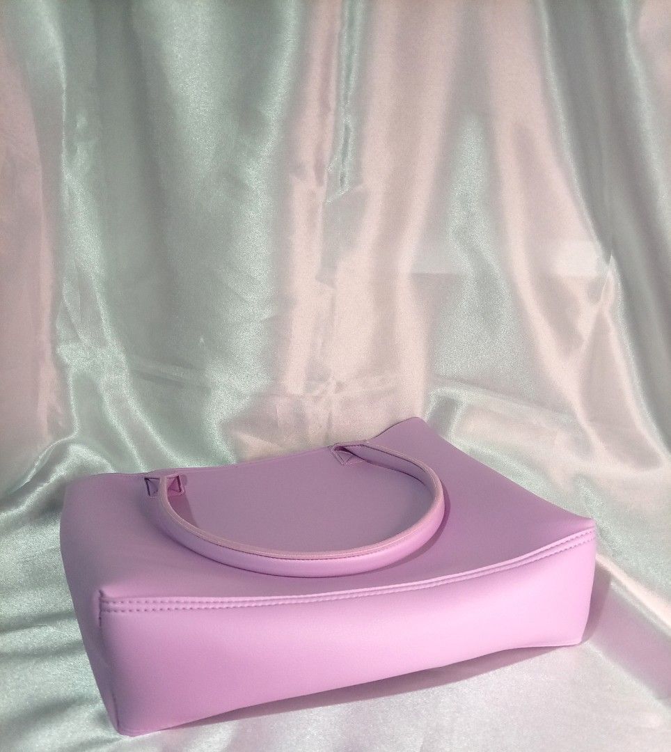 Purple BTS Heart Accent Tote Bag (Category: Tote Bags) located in Manila. Submitted by btsinpurple (Listing ID 1467691716, Image 2). Description: - Color: Light purple - Material: Smooth synthetic leather - Closure: Top zipper with matching pull - Inclusion: Heart-shaped BTS logo bag charm - Features: Twin carry handles and clean solid interior lining - Capacity: Roomy size perfect for daily essentials - Quality: Neat stitching along all seams an