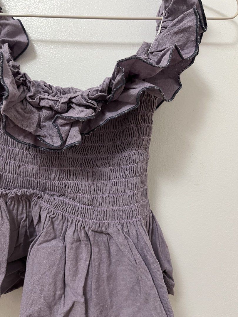Purple Ruffle Off-Shoulder Smocked Blouse (Category: Blouses) located in Batangas. Submitted by povofkbscloset (Listing ID 1467671420, Image 3). Description: - Color: Dusty purple - Details: Ruffles around neckline and shoulders, flared peplum hem - Fit: Smocked body that stretches nicely - Condition: Worn once, still looks great - Styling: Pairs easily with high-waisted pants or jeans.