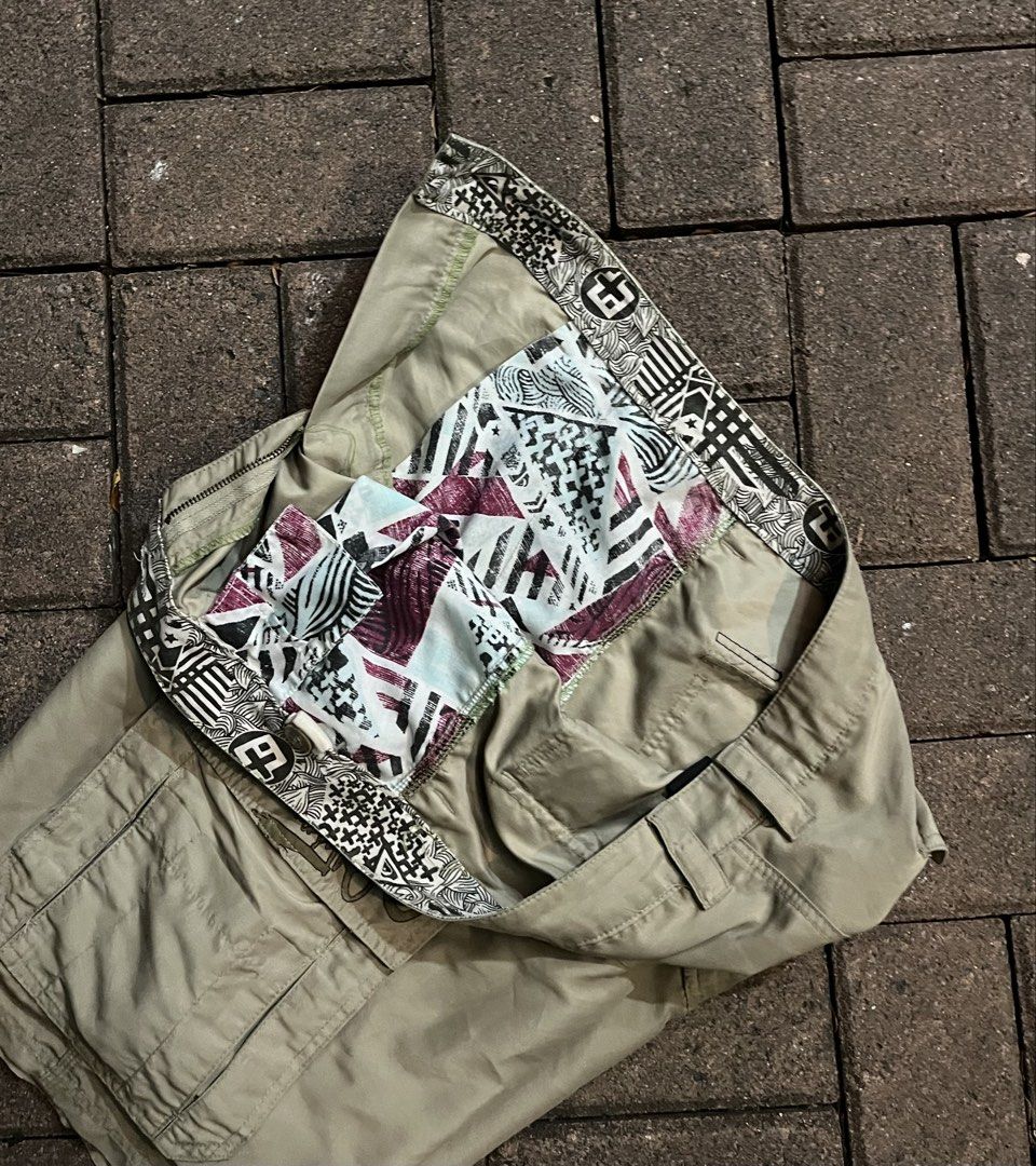 Quiksilver Khaki Cargo Shorts With Patterned Lining (Category: Shorts) located in Manila. Submitted by rusell_inmotion (Listing ID 1467825098, Image 3). Description: - Brand: Quiksilver - Color: Khaki - Style: Cargo shorts with multiple side utility pockets and embroidery branding - Design: Cool graphic pattern lining inside the waistband and pockets - Details: Button closure with belt loops - Condition: Ready to wear, solid everyday wear.