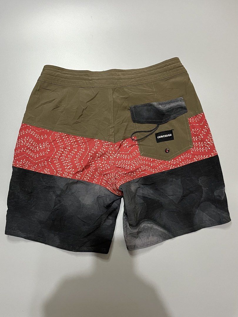 Quiksilver x Will Lounge Board Shorts Multi-color (Category: Swim Trunks & Board Shorts) located in Manila. Submitted by jorgemabelin2001 (Listing ID 1467760376, Image 2). Description: - Brand: Quiksilver x Will Lounge collaboration - Design: Tri-color blocked (olive green top, red patterned middle, dark grey bottom) - Details: Back pocket with Quiksilver logo patch and matching Will Lounge hem print - Waist: Adjustable drawstring with black lace