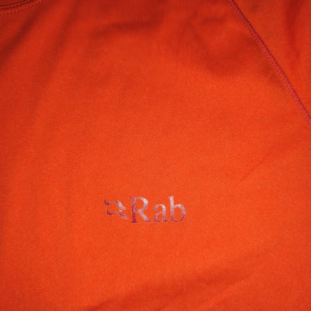 Rab Orange T-Shirt (Category: Activewear) located in Antipolo. Submitted by alphaomega_fox (Listing ID 1467714062, Image 3). Description: - Brand: Rab - Color: Bright orange - Size: UK M / US M, 20x27 - Material: Comfortable athletic fabric, dri fit - Features: Short sleeves, crew neck - Condition: excellent condition - Ideal for: Hiking, running, or casual outdoor days 800 plus sf.