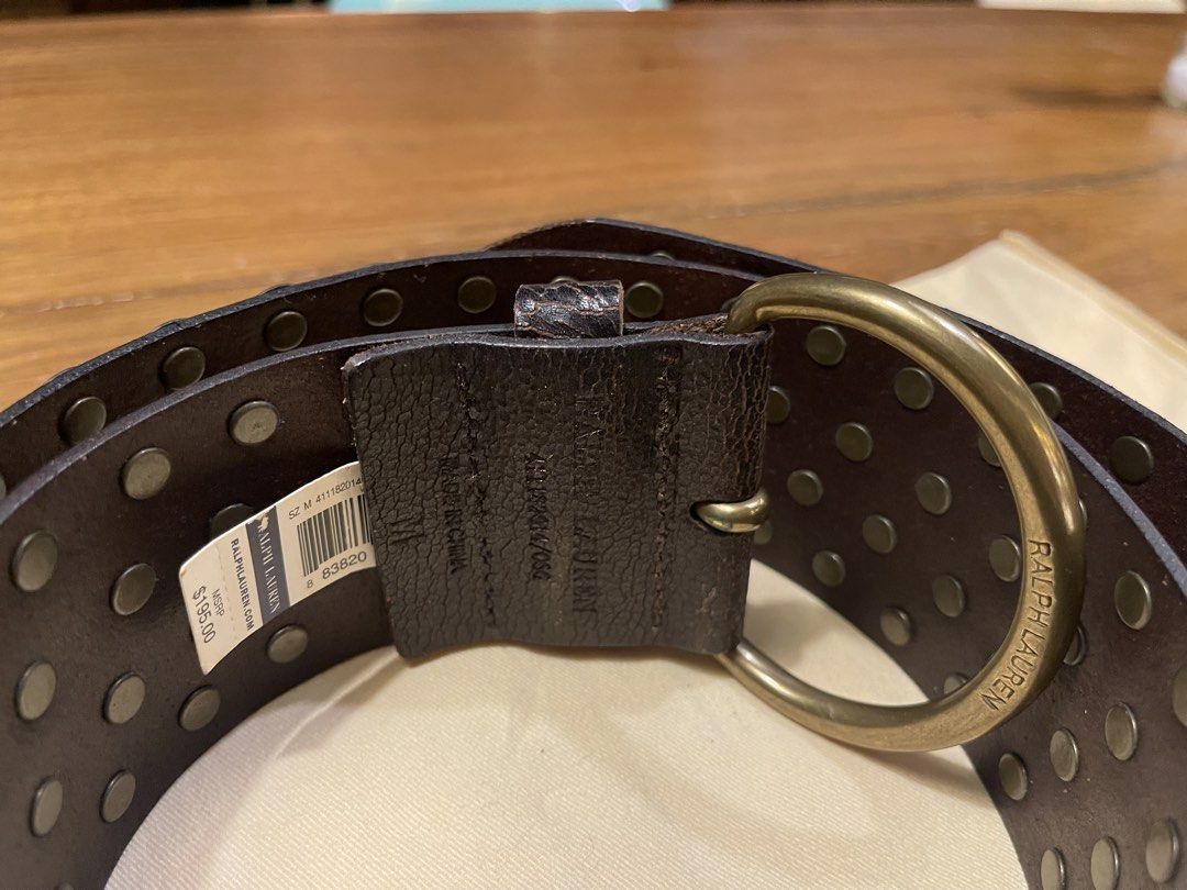 Ralph Lauren Studded Leather Belt (Category: Belts) located in Quezon City. Submitted by vaugncruz08 (Listing ID 1467589224, Image 2). Description: - Color: Dark brown leather - Details: Multiple rows of round brass-toned studs with dark metal grommets - Hardware: Heavy buckle design and substantial hardware - Condition: Brand new, tag attached, never worn - Negotiable.