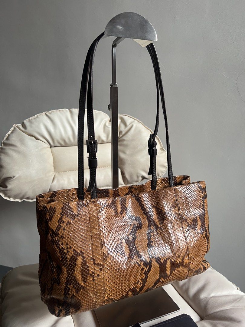 Rare Prada Python — Exotic Pattern (Category: Luxury Bags & Wallets) located in Bacoor. Submitted by mikaysu (Listing ID 1467825110, Image 3). Description: Prada python tote featuring a striking snakeskin pattern, glossy textured finish, and sleek leather handles. A statement piece that brings a bold, vintage-inspired luxury aesthetic to any outfit. Details: Brand: Prada Style: Pythontote bag Pattern: Snakeskin Includes: Prada cards — care card a