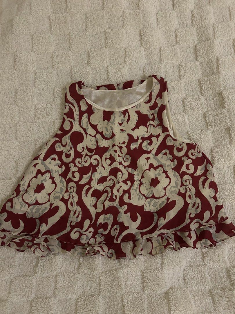 Red and Beige Floral Pattern Sleeveless Crop Top (Category: Sleeveless) located in Quezon City. Submitted by bae.randa (Listing ID 1467627970, Image 1). Description: - Style: Red and beige patterned crop top - Design: Sleeveless with a round neckline and double-layered ruffle hem .