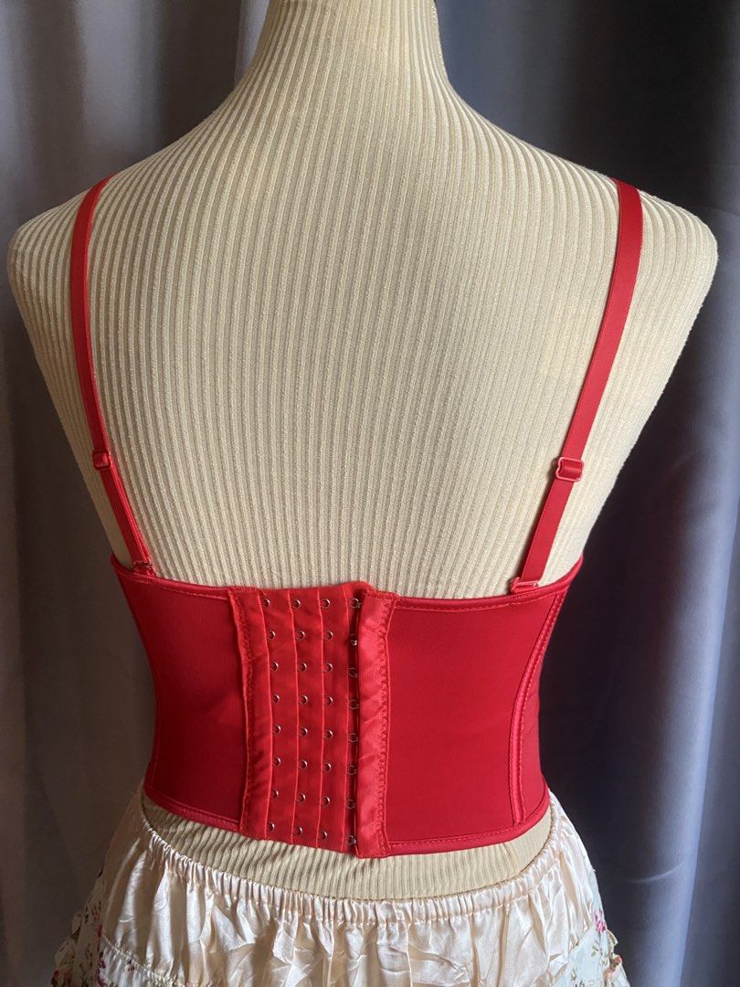 Red Boned Corset Bustier Top (Category: Sleeveless) located in Cagayan de Oro. Submitted by curated_closetph (Listing ID 1467760047, Image 3). Description: — Size : XS - S — Color: Red — Structured boning down the front for a flattering fit — Padded underwire cups for supportive shaping — Adjustable spaghetti straps for a customizable fit — Multi-row hook-and-eye back closure for security and adjustment — Dip-hem pointed baseline that accentuates