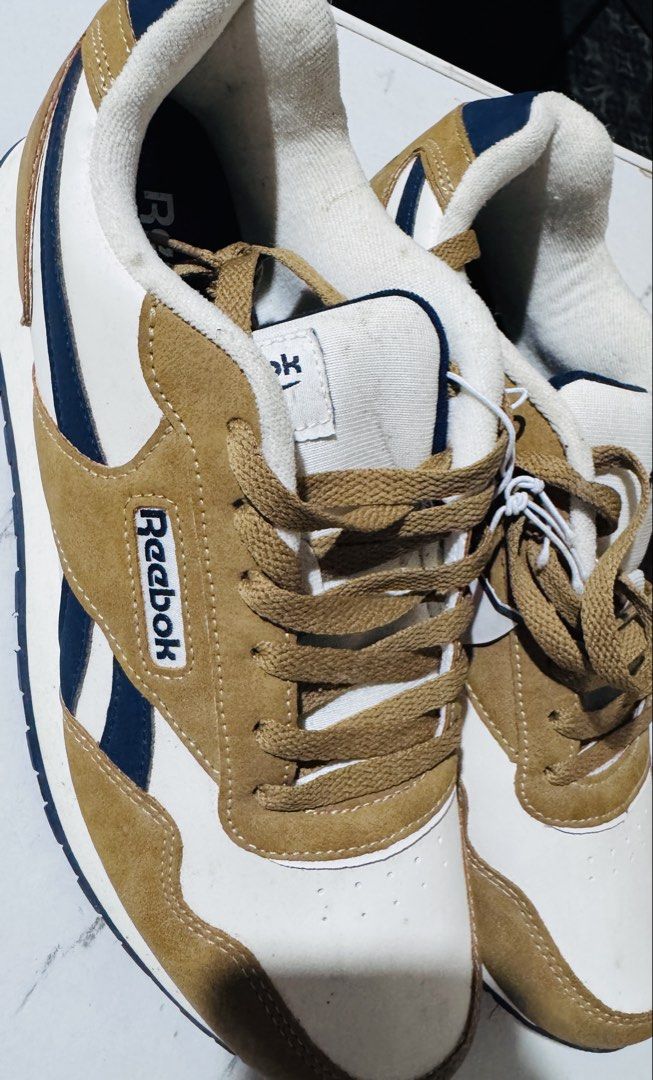 Reebok Sneakers White Brown Navy Size 9.5 (Category: Casual Shoes) located in Manila. Submitted by alyssamaec59008 (Listing ID 1467659208, Image 2). Description: Brand new Reebok classic sneakers in size 9.5, featuring a stylish white, brown, and navy colorway with suede overlays and tags still attached..