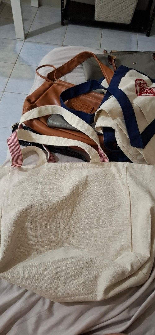 Reversible canvas tote bag (Category: Tote Bags) located in Paranaque City. Submitted by finders_thriftersph (Listing ID 1467737333, Image 2). Description: - Color: Cream with red typography and heart detail - Quote: "C'est La Vie" - Straps: Dual cream top handles + double striped red and white shoulder straps - Interior: Red and white striped lining - Size: Roomy everyday carryall - Perfect for: Groceries, books, school, work, or daily essential